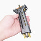 Hand holding a metallic gun slide with '