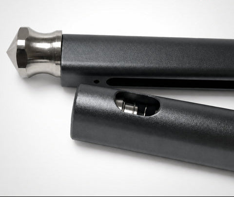 Close-up of a black cylindrical object with a metallic tip on a white background, featuring a logo in the corner.