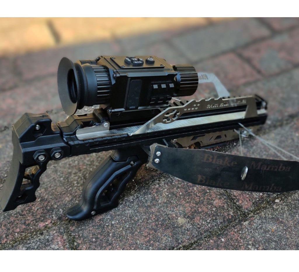 Crossbow with scope and knife on a textured surface, branded 'Survival'.